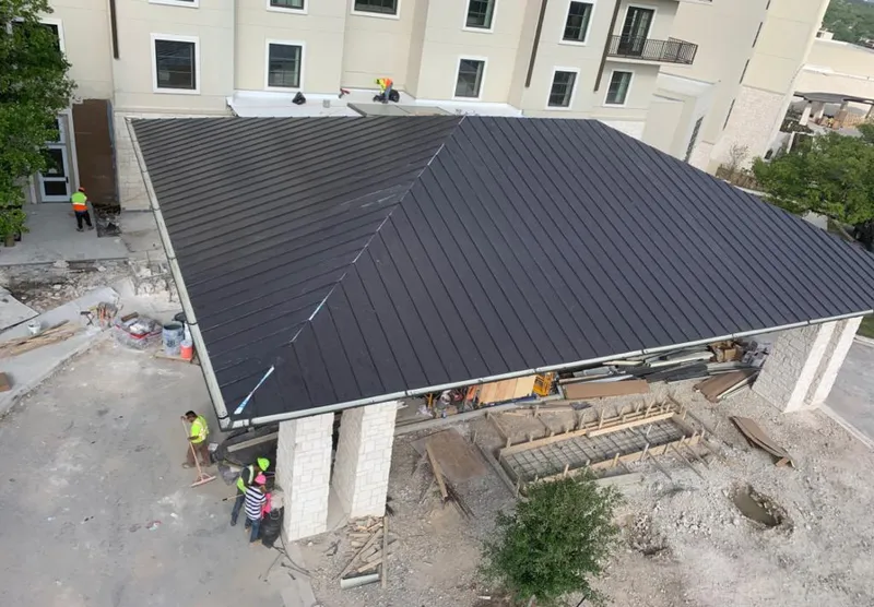 Metal roofing installation team working on a commercial building in Sidney